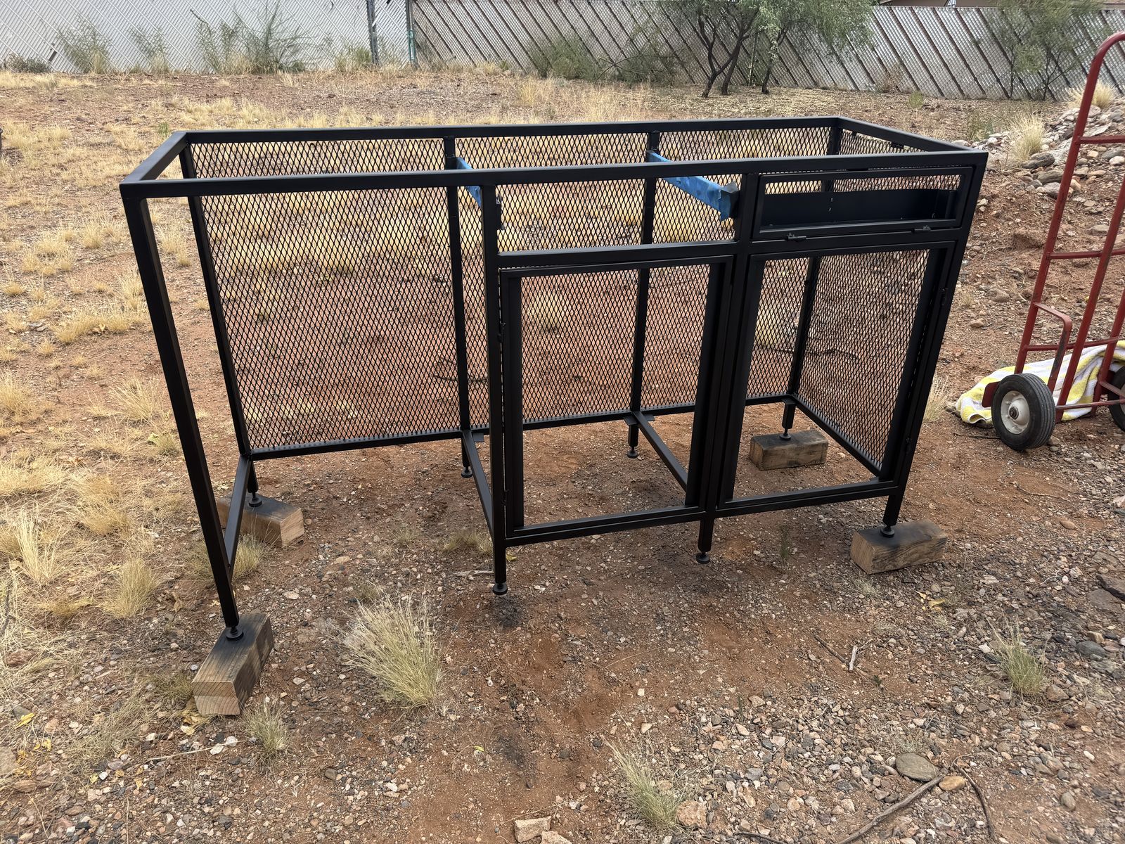 Frames painted black and curing outside.