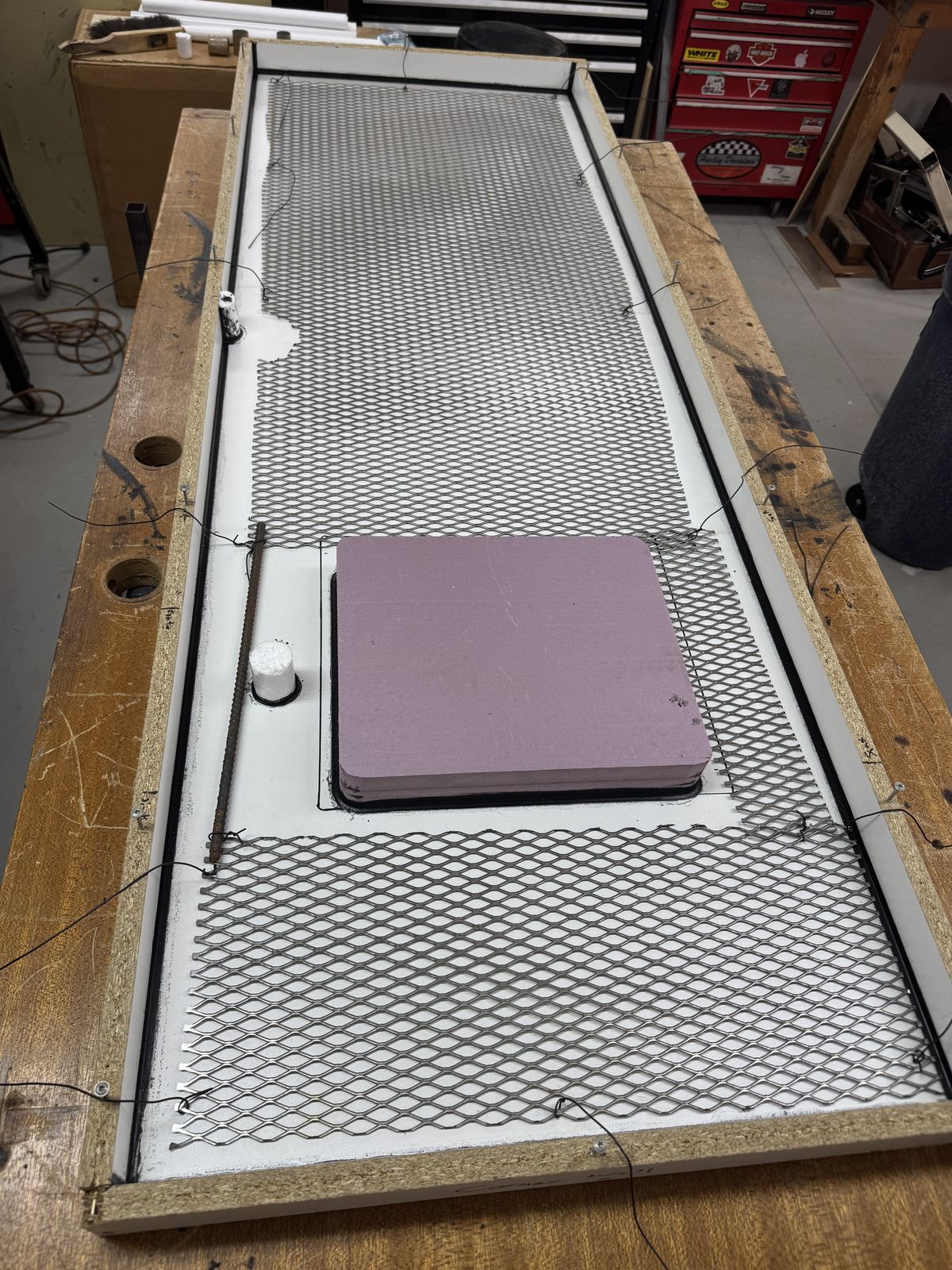 Concrete countertop mold with steel mesh reinforcement and a knockout for the sink.