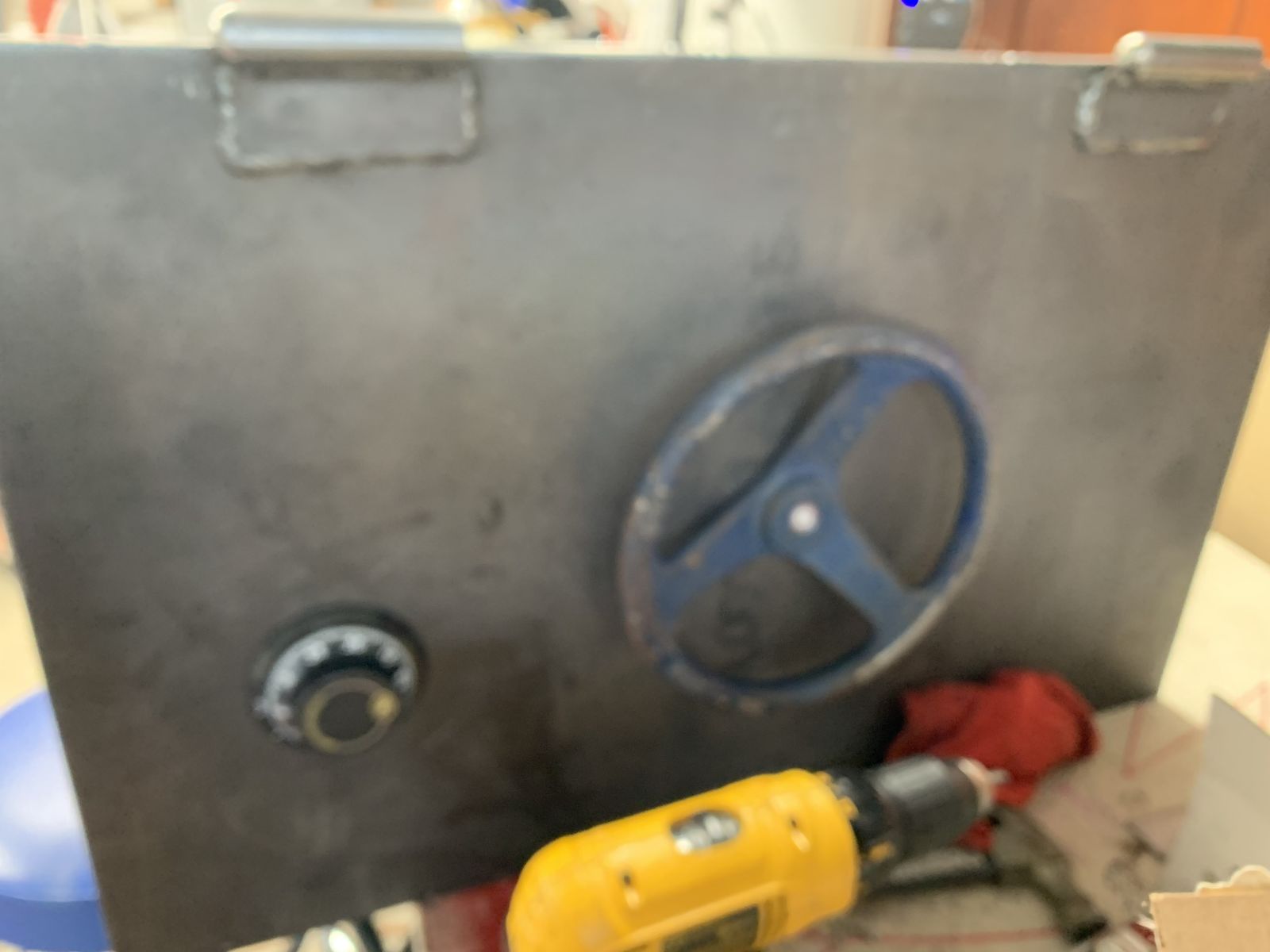 Door face: combination dial plus a water shut-off valve wheel as the handle.